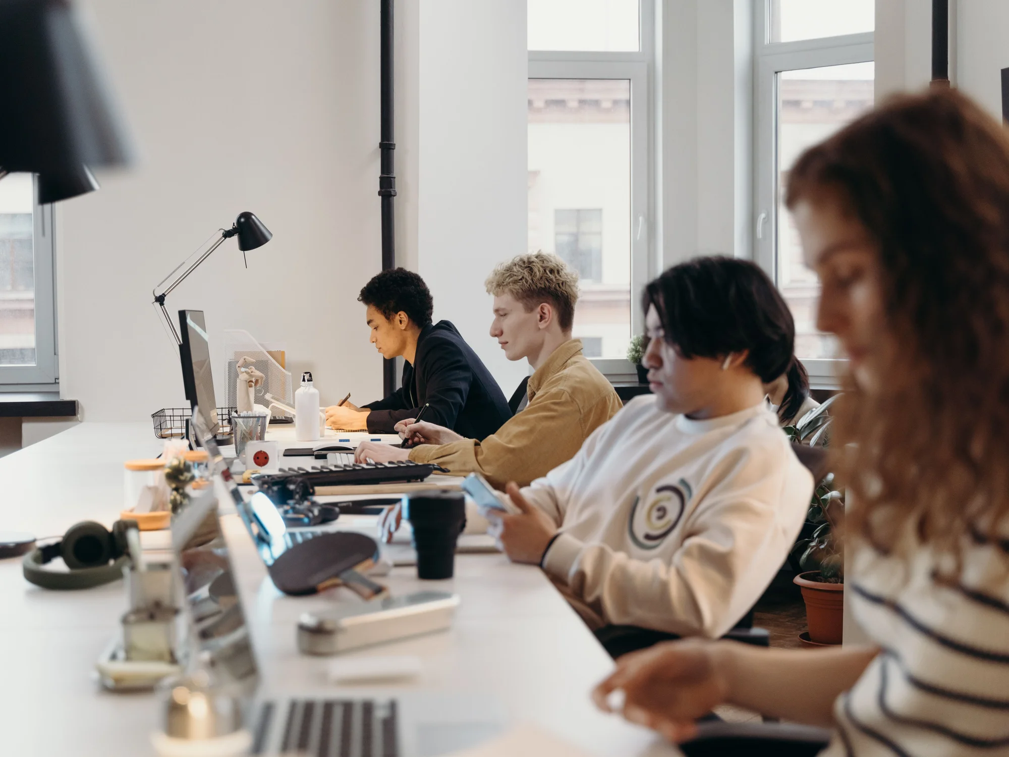 A team working on laptops in a bright office